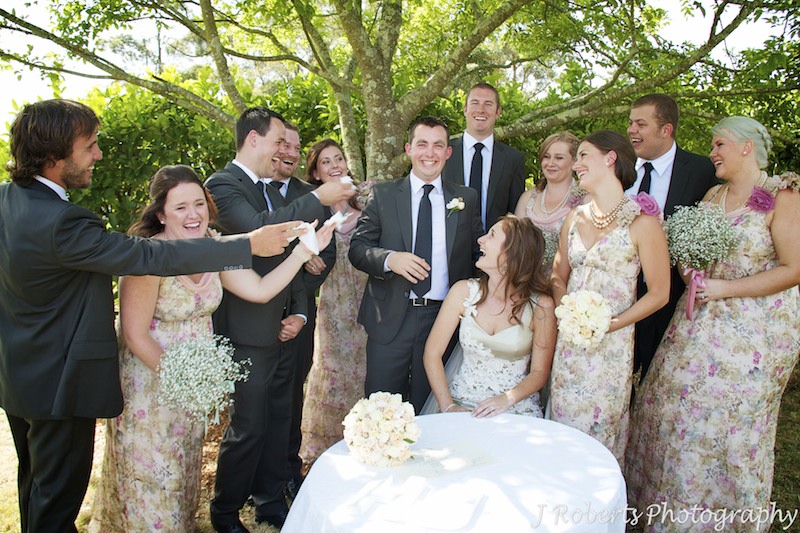Bridal party offering groom tissues after emotional wedding ceremony - wedding photography sydney